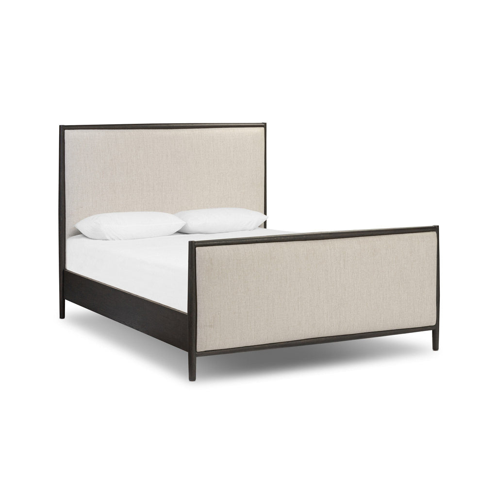 Bed with beige upholstered headboard and black frame on a white background