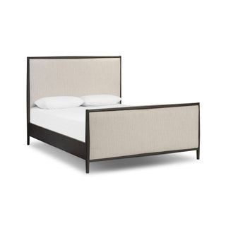 Bed with beige upholstered headboard and black frame on a white background